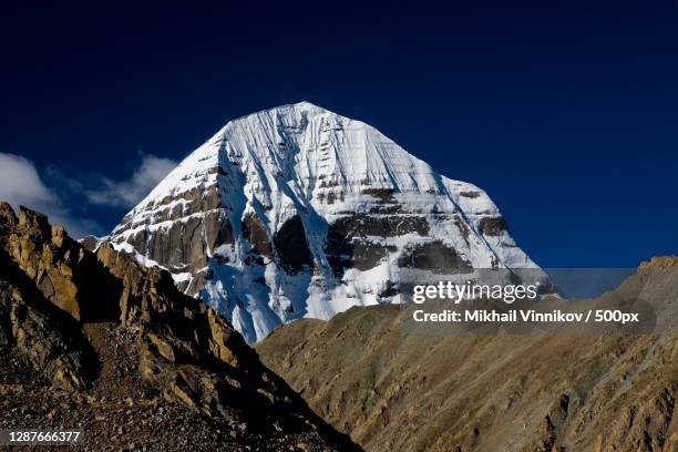 low angle view of snowcapped mountains against clear blue sky,china - mount kailash kora stock pictures, royalty-free photos & images