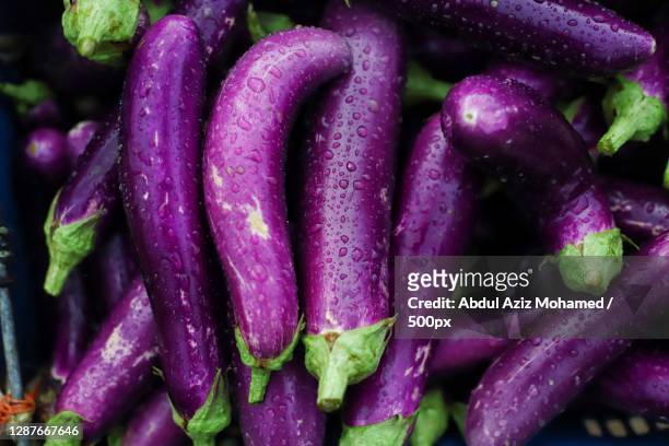 close-up of eggplants on table - aubergine fotografías e imágenes de stock