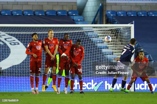 Jed Wallace of Millwall scores their team's first goal from a freekick during the Sky Bet Championship match between Millwall and Reading at The Den...