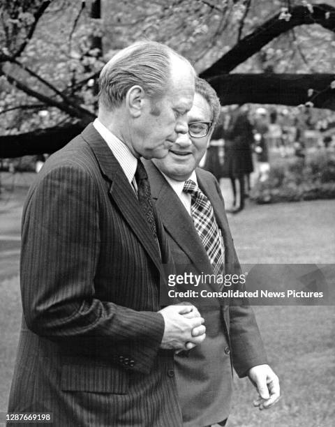 President Gerald Ford and Secretary of State Henry Kissinger talk as they walk through the White House's Rose Garden, Washington DC, April 29, 1975....