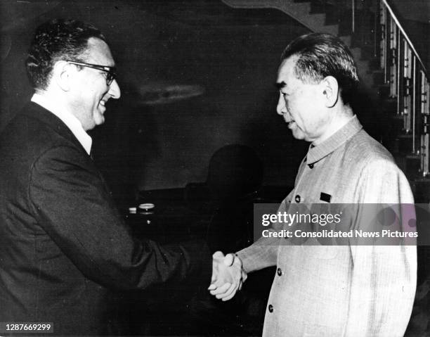 National Security Advisor Henry Kissinger and Chinese Premier Chou En-lai shake hands at the Government Guest House, Beijing, China, July 9, 1971.