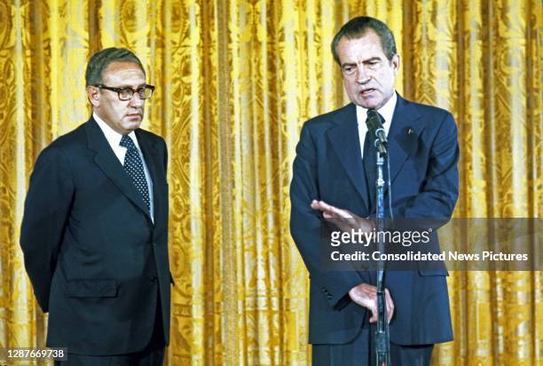 Secretary of State-designate Henry Kissinger , listens as US President Richard Nixon speaks, in the White House's East Room, prior to Kissinger...