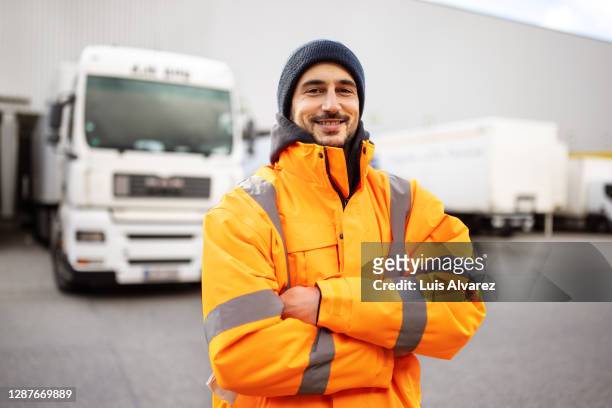 shipping yard worker standing outdoors - driver portrait stockfoto's en -beelden