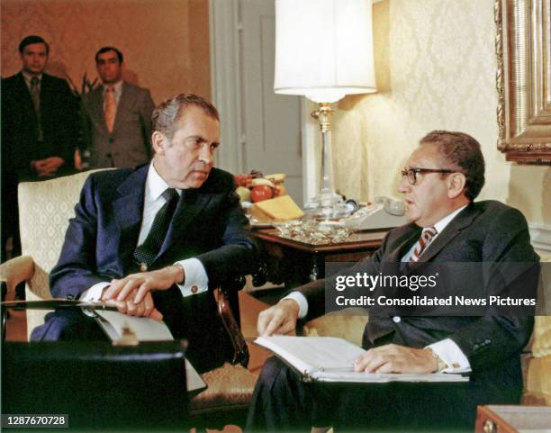 President Richard Nixon and National Security Advisor Henry Kissinger talk together, Washington DC, November 25, 1972.