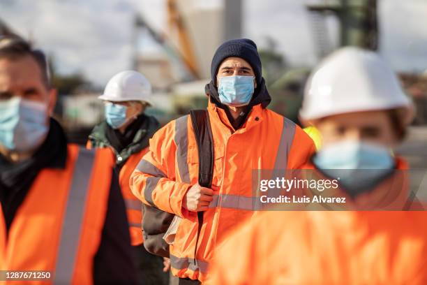 shipping yard workers going home after work - blue collar worker mask stock pictures, royalty-free photos & images