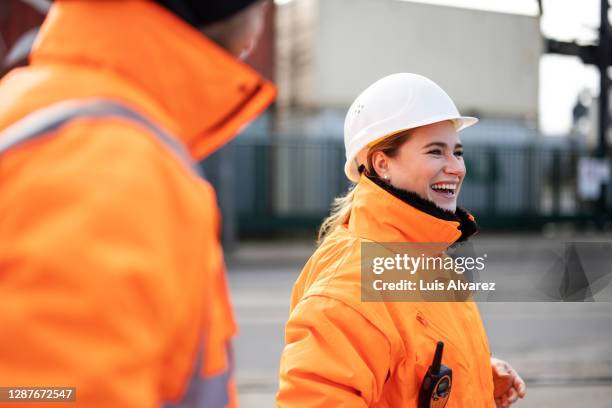 smiling female engineer at the shipyard - casco de trabajo fotografías e imágenes de stock