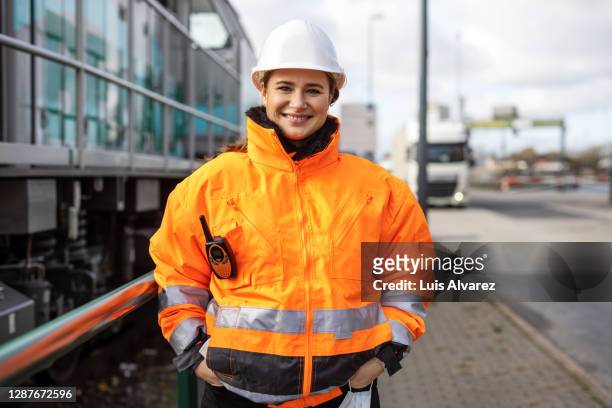 confident female engineer at commercial dockyard - railing imagens e fotografias de stock