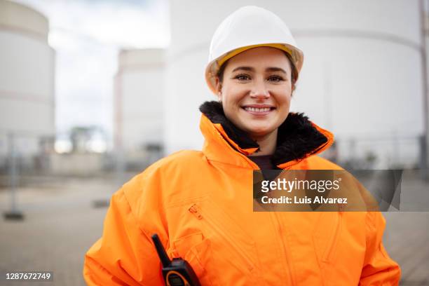 portrait of happy young female refinery engineer - refinery fotografías e imágenes de stock