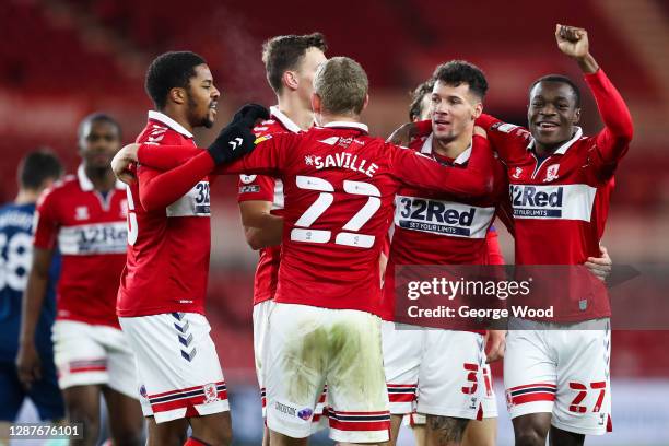 Marvin Johnson of Middlesbrough celebrates with Marc Bola and George Saville after scoring their team's third goal during the Sky Bet Championship...