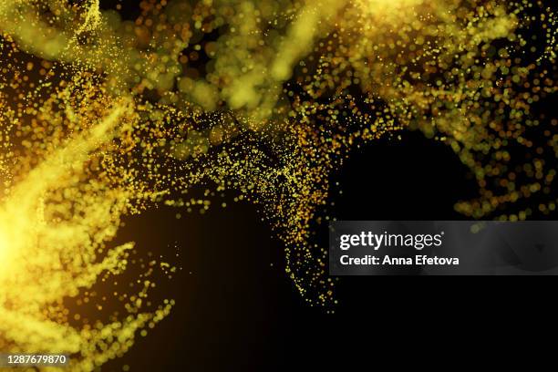 splash of illuminating particles on black background - fly spray stock pictures, royalty-free photos & images