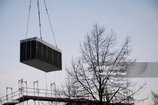 a crane lifts a prefabricated and sealed module for the construction of a building. germany. - temporary office stock pictures, royalty-free photos & images