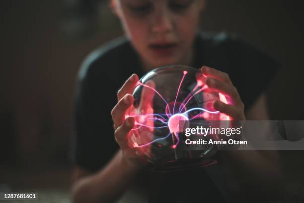 boy playing with a plasma lamp - real life science stock pictures, royalty-free photos & images