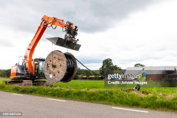 view of digger at work - cable spool stock pictures, royalty-free photos & images