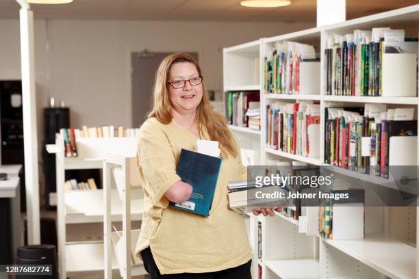 portrait of librarian holding a book - sweden kalmar stock pictures, royalty-free photos & images
