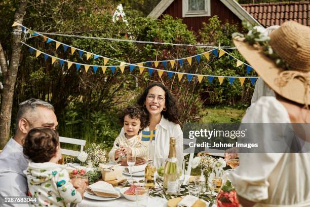 family having meal in garden - swedish culture fotografías e imágenes de stock