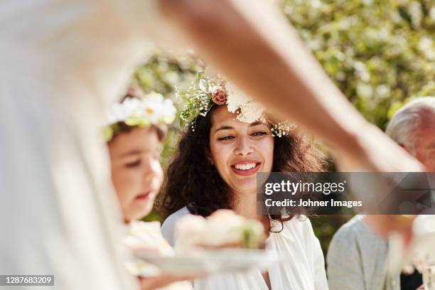 smiling woman sitting at table - summer solstice soiree stock pictures, royalty-free photos & images