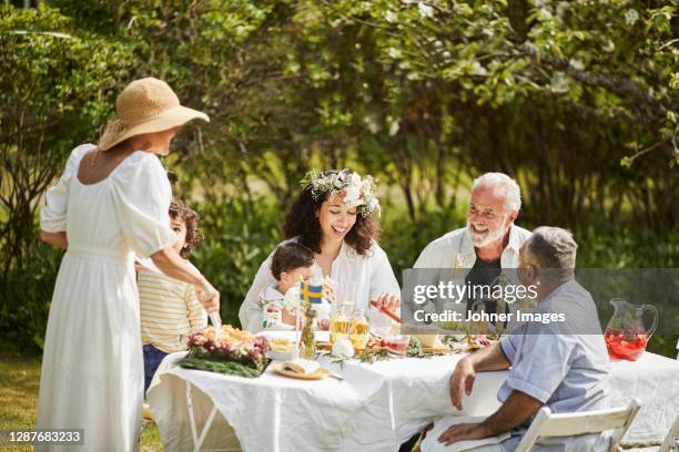 friends having party in garden - summer solstice soiree stock pictures, royalty-free photos & images