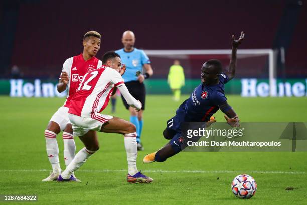 Awer Mabil of FC Midtjylland is fouled by Noussair Mazraoui of Ajax and a penalty is awarded during the UEFA Champions League Group D stage match...