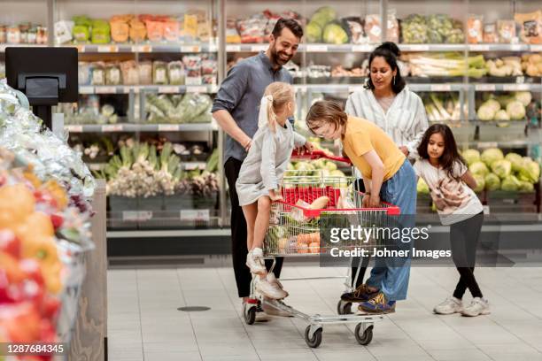 family doing shopping in supermarket - family shopping stock pictures, royalty-free photos & images