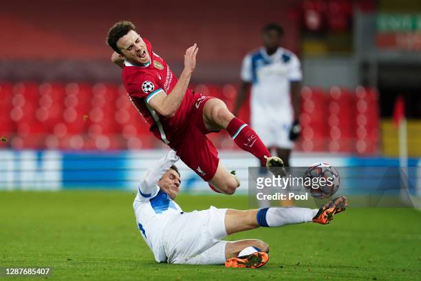 Diogo Jota of Liverpool is challenged by Marten de Roon of Atalanta B.C. During the UEFA Champions League Group D stage match between Liverpool FC...