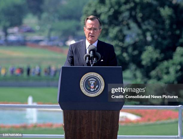 On the White House's South Lawn, US President George HW Bush speaks prior to the signing ceremony of the Americans with Disabilities Act of 1990 ,...