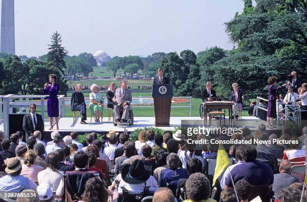 On the White House's South Lawn, US President George HW Bush speaks prior to the signing ceremony of the Americans with Disabilities Act of 1990 ,...