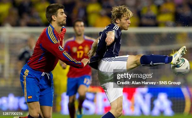 V SCOTLAND.ESTADIO JOSE RICO PEREZ - ALICANTE.Scotland's Craig Mackail-Smith holds off Gerard Pique