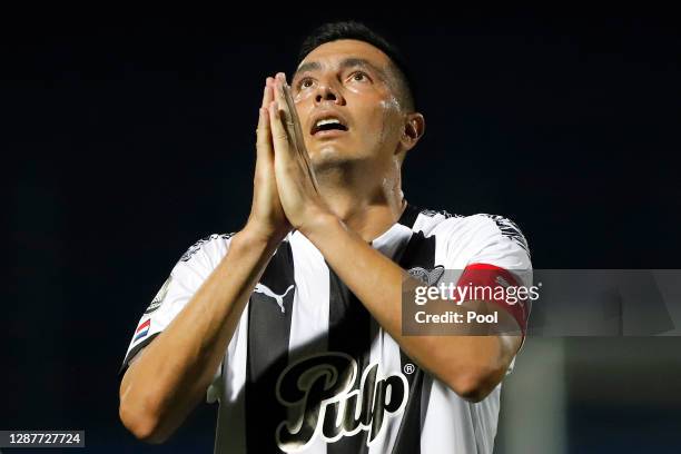 Óscar Cardozo of Libertad prays in honor of late Argentina football star Diego Maradona after scoring the second goal of his team during a round of...