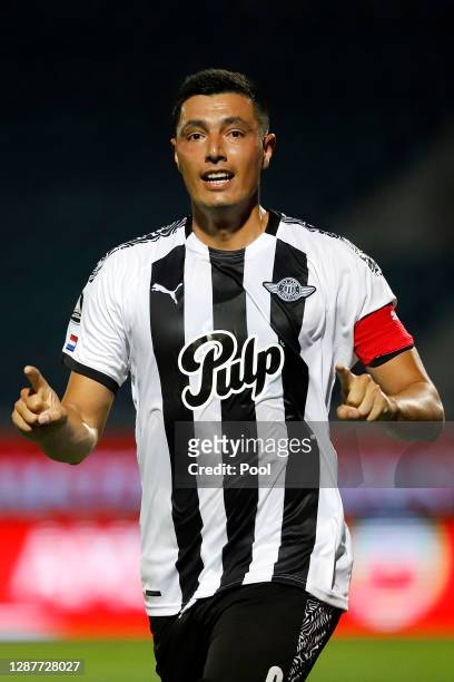 Óscar Cardozo of Libertad celebrates in honor of late Argentina football star Diego Maradona after scoring the second goal of his team during a round...