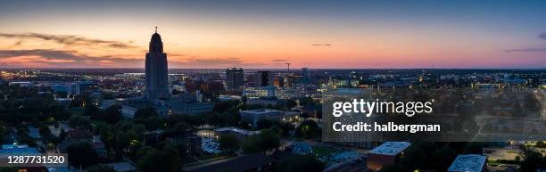 lincoln, nebraska at twilight - aerial panorama - lincoln and center stock pictures, royalty-free photos & images