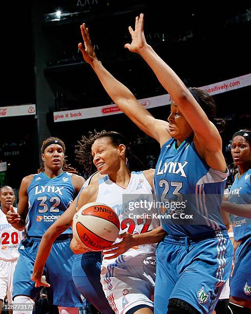 Armintie Price of the Atlanta Dream collides with Maya Moore of the Minnesota Lynx in Game Three of the 2011 WNBA Finals at Philips Arena on October...