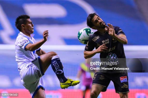 Fernando Navarro of León struggles for the ball against Osvaldo Martínez of Puebla during the quarterfinals first leg match between Puebla and Leon...