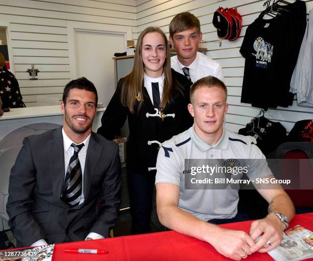 St Mirren's Lewis Guy , Grant Adam and Thomas Reilly are all smiles as they sign autographs for fans in the club shop before kick-off.