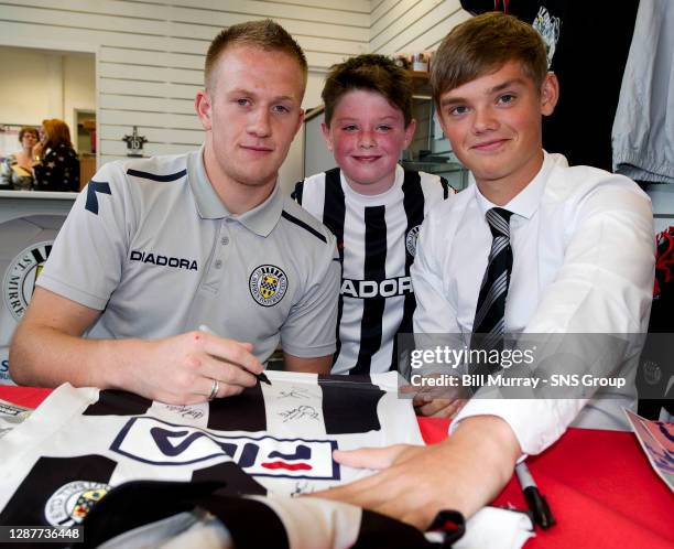 St Mirren's Grant Adam and Thomas Reilly meet a young fan as they sign his shirt prior to kick-off.