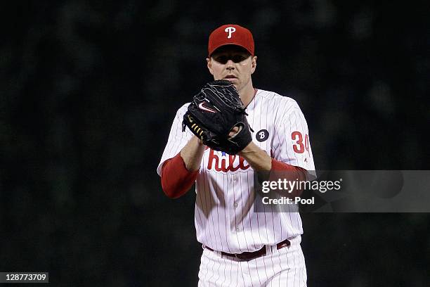 Roy Halladay of the Philadelphia Phillies gets set to throw a pitch against the St. Louis Cardinals during Game Five of the National League...