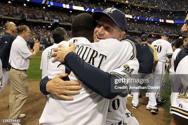 Yuniesky Betancourt and manager Ron Roenicke of the Milwaukee Brewers celebrate after the Brewers defeat the Arizona Diamondbacks in Game Five of the...