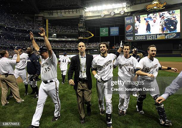 First base coach Garth Iorg, Ryan Braun, Craig Counsell and Jonathan Lucroy of the Milwaukee Brewers celebrate their 3-2 10 inning victory against...