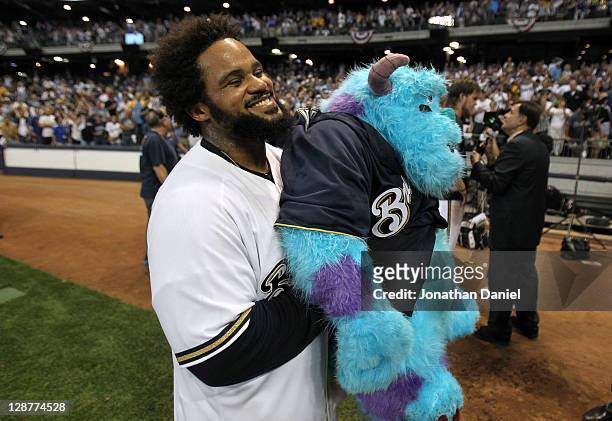 Prince Fielder of the Milwaukee Brewers celebrates with a stuffed animal after the Brewers 3-2 10 inning victory against the Arizona Diamondbacks in...