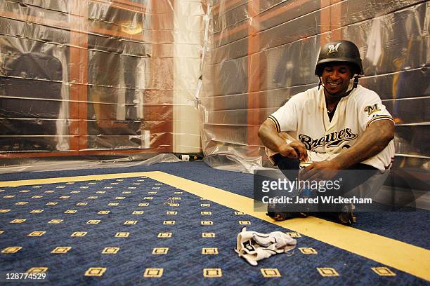 Nyjer Morgan of the Milwaukee Brewers has a moment to himself in the clubhouse following their win against the Arizona Diamondbacks in Game Five of...