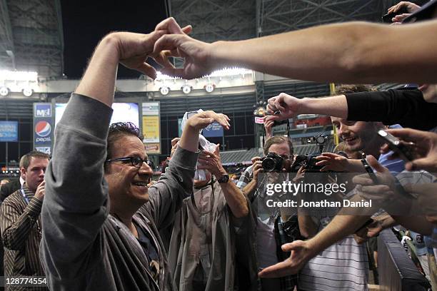 Owner Mark Attanasio of the Milwaukee Brewers celebrates with fans after the Brewers 3-2 10 inning victory against the Arizona Diamondbacks in Game...