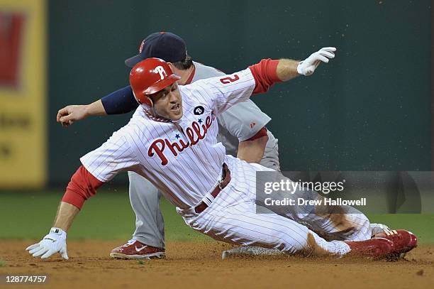 Chase Utley of the Philadelphia Phillies is caught attempting to steal second base in the bottom of the sixth inning against Nick Punto of the St....