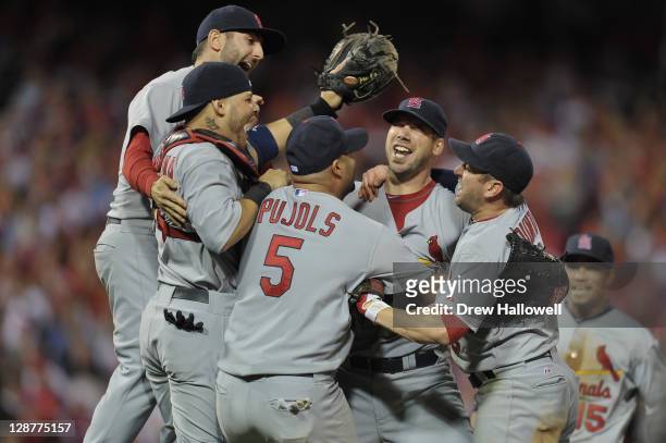 Albert Pujols and Chris Carpenter of the St. Louis Cardinals celebrate with their teammates after they won 1-0 againt the Philadelphia Phillies...