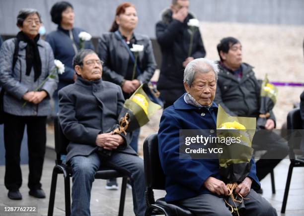 Survivors and family members of victims attend a memorial ceremony at the Memorial Hall of the Victims in Nanjing Massacre by Japanese Invaders on...