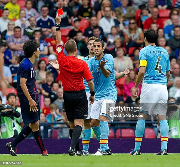 V JAPAN.HAMPDEN - GLASGOW.American referee Mark Geiger shows a red card to Spain's Inigo Martinez as team-mate Alvaro Dominguez pleads his case