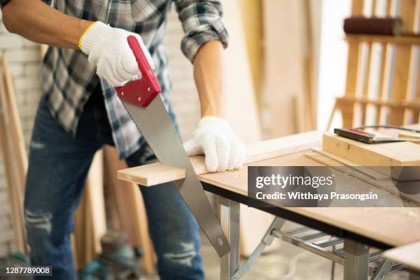 carpenter with circular saw - sawing stock-fotos und bilder