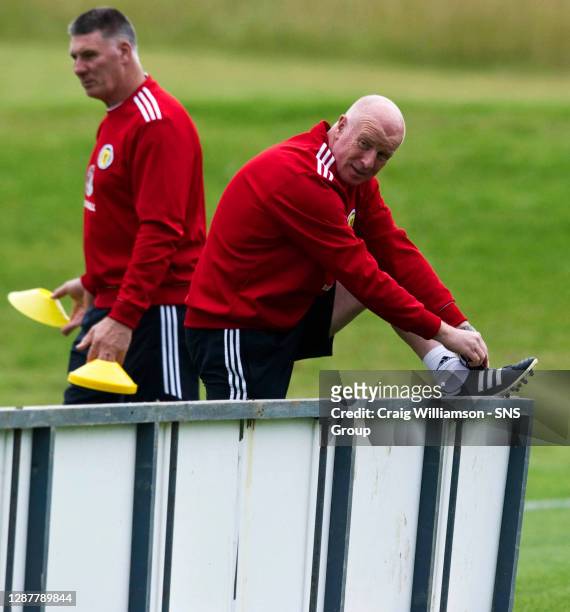 Scotland assistant manager Peter Houston laces up his boots as he prepares to take the squad training ahead of the FIFA World Cup 2014 Qualifying...