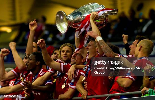 Bastian Schweinsteiger lifts the UEFA Champions League trophy as Bayern Munich are crowned kings of Europe.