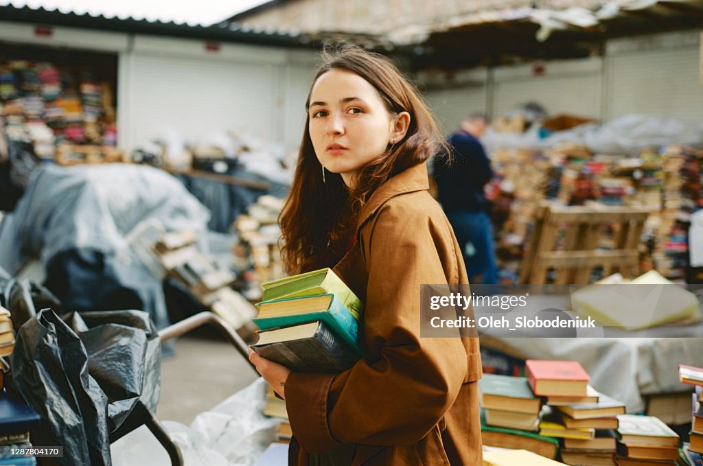 Woman buying books on vintage book market