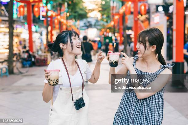 happy asian women with bubble tea - taiwanese stock pictures, royalty-free photos & images