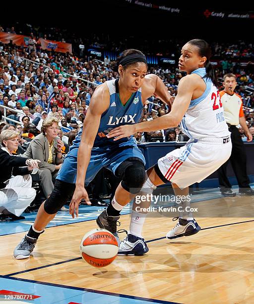 Maya Moore of the Minnesota Lynx drives against Armintie Price of the Atlanta Dream in Game Three of the 2011 WNBA Finals at Philips Arena on October...